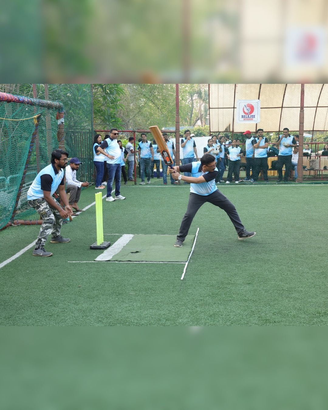 Colleagues taking part in a cricket match